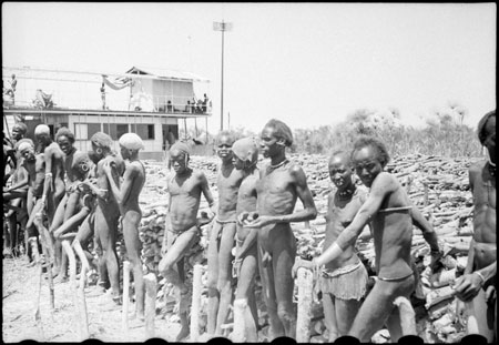 Nuer men with fuelwood