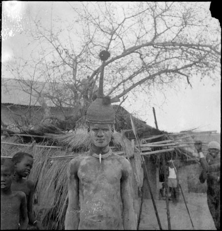 Dinka youth wearing basketry hat