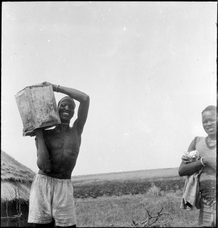 Man carrying metal tin