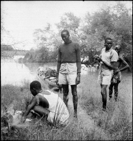 Dinka porters with camp fire