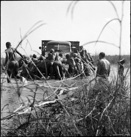 Dinka men rescuing truck