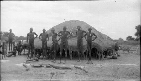 Dinka men outside luak