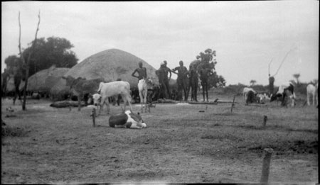 Dinka men outside luak