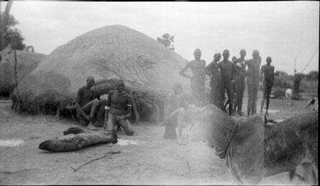 Dinka men outside luak