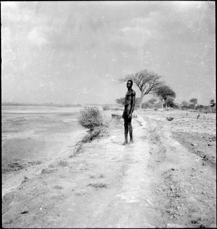 Dinka man on a riverbank