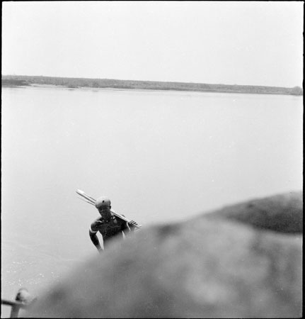 Dinka youth by a river