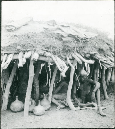 Dinka men under shelter