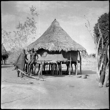 Mandari couple outside hut