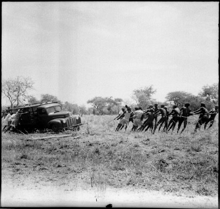 Dinka men pulling truck